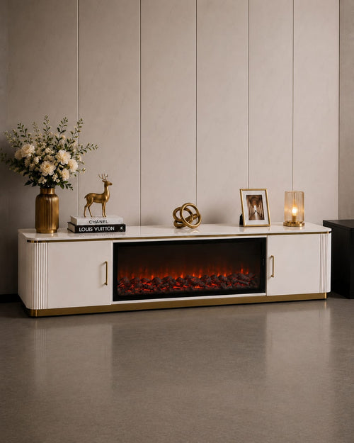 Modern white TV unit with built-in electric fireplace, gold accents, and decorative items for living room