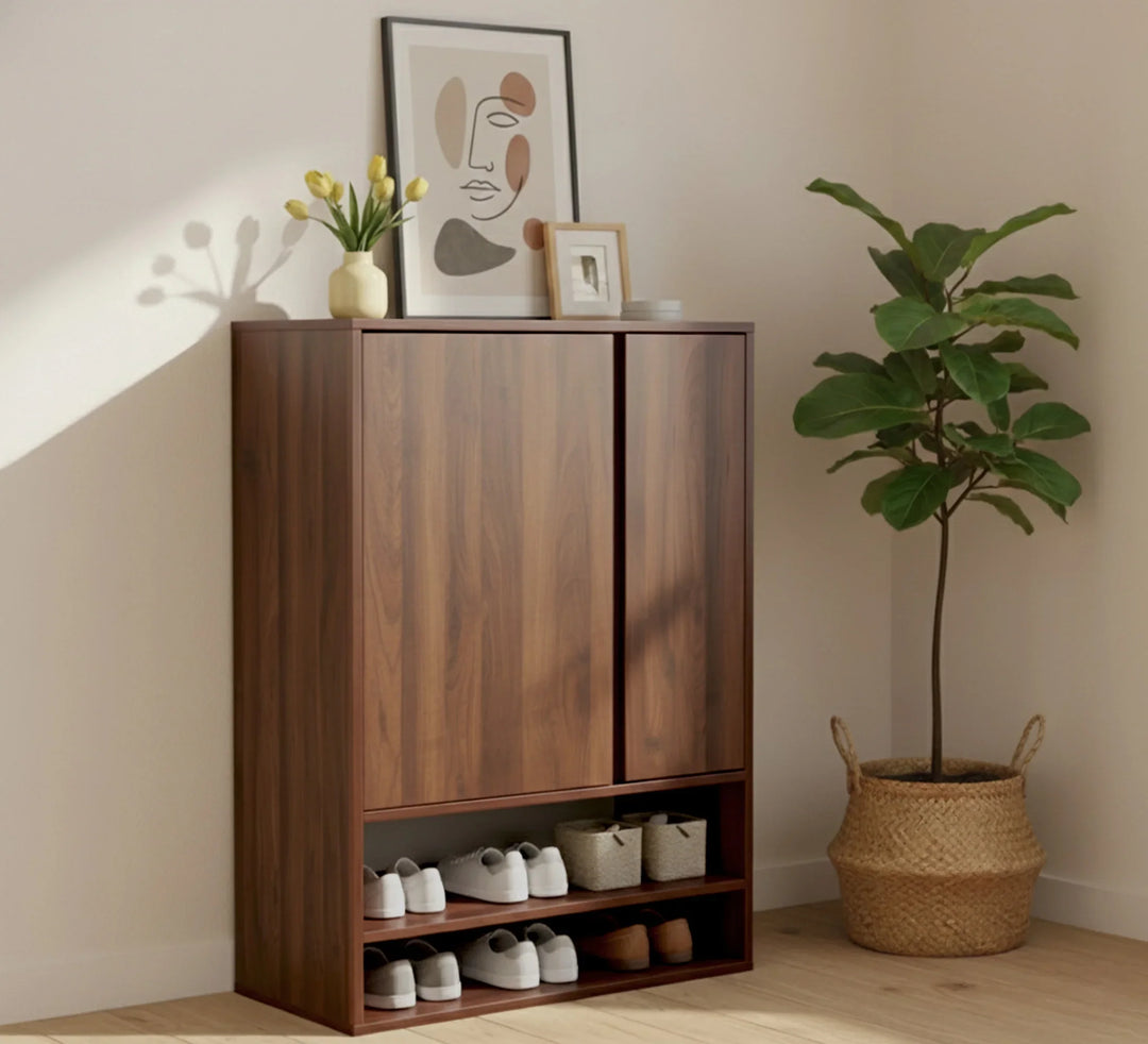 Modern wooden shoe cabinet in a bright room with potted plant and decorative artwork.