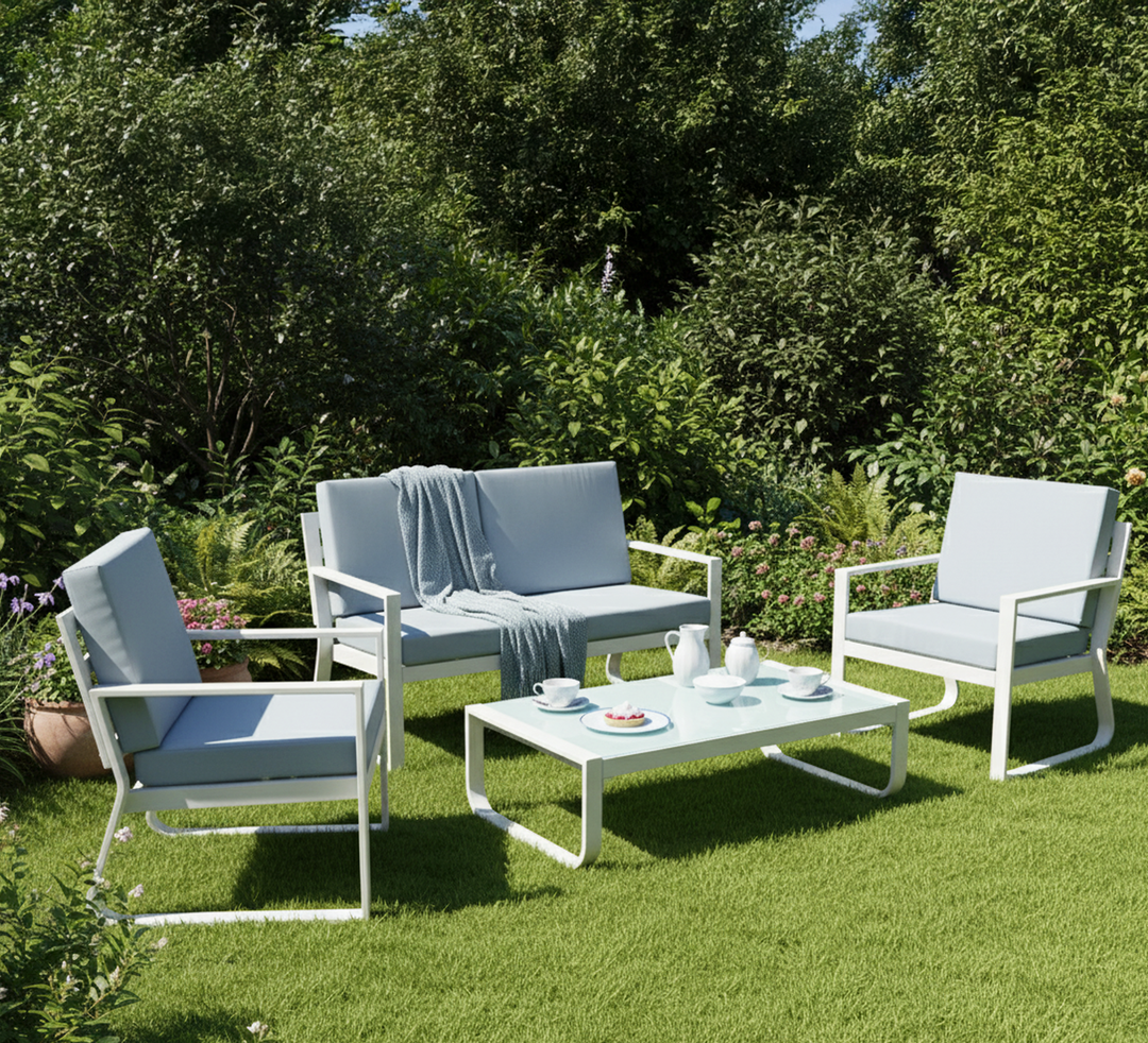 Modern outdoor patio furniture set with white frame, light blue cushions, and coffee table on grass