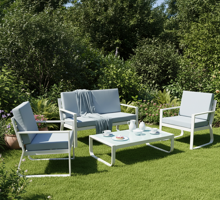 Modern outdoor patio furniture set with white frame, light blue cushions, and coffee table on grass
