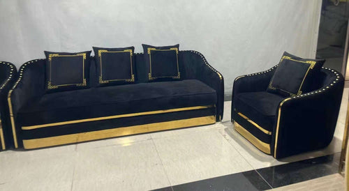 Luxury black velvet sofa set with gold trim and matching armchair, ideal for modern living rooms