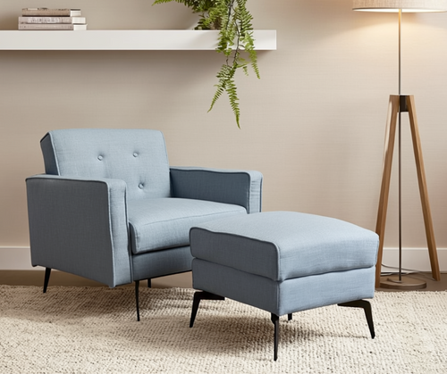 Modern light blue armchair with matching ottoman in a cozy living room setting