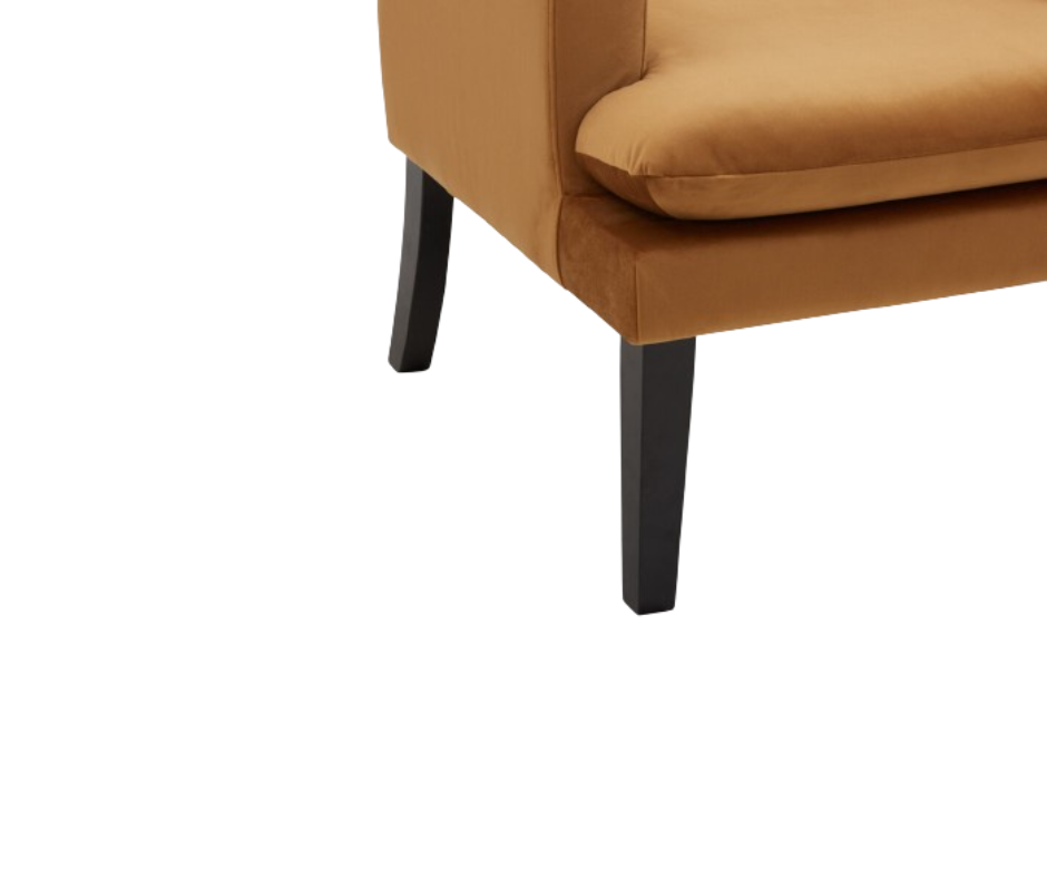 Corner view of a modern tan upholstered chair with black wooden legs
