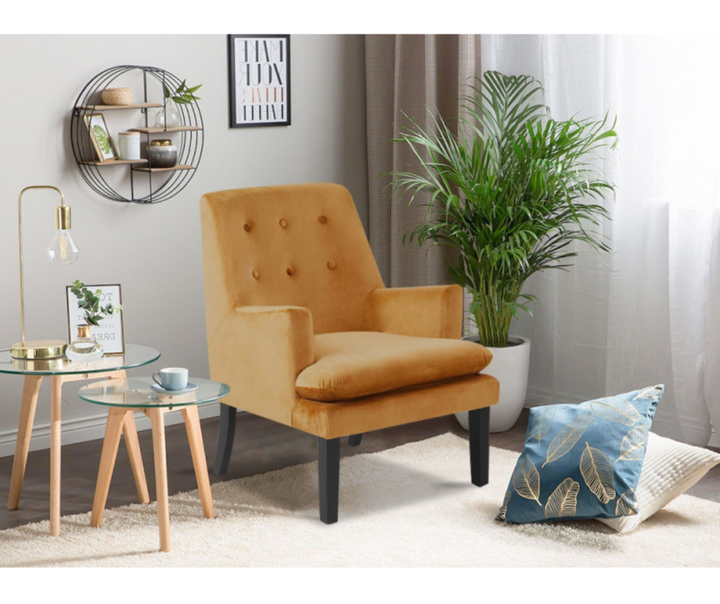 Modern living room with mustard yellow accent chair, glass side tables, green plant, and decorative pillows