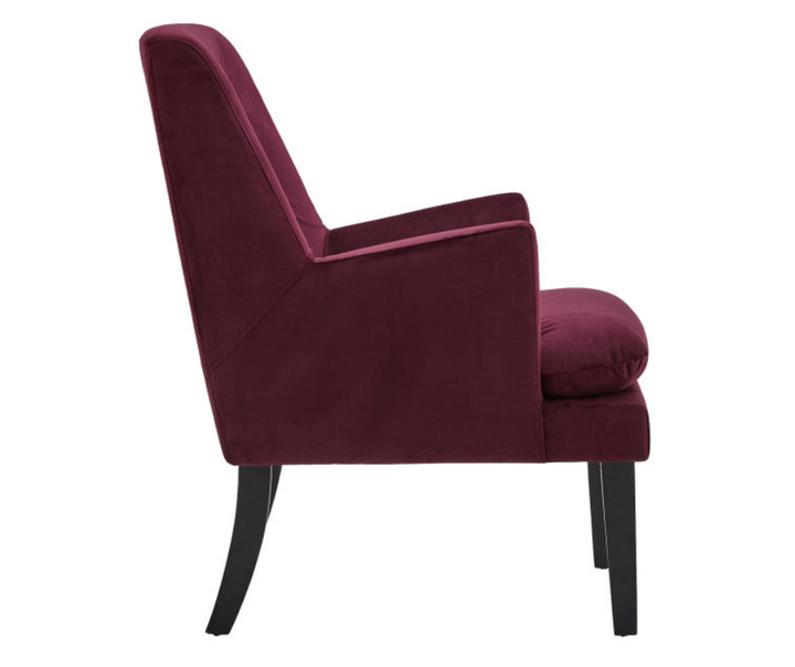 Side view of a modern plum velvet accent chair with black wooden legs