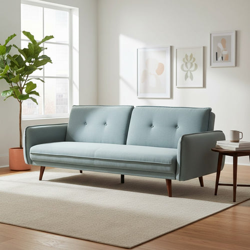 Light blue mid-century modern sofa with tufted back, wooden legs, in bright living room with rug and plant