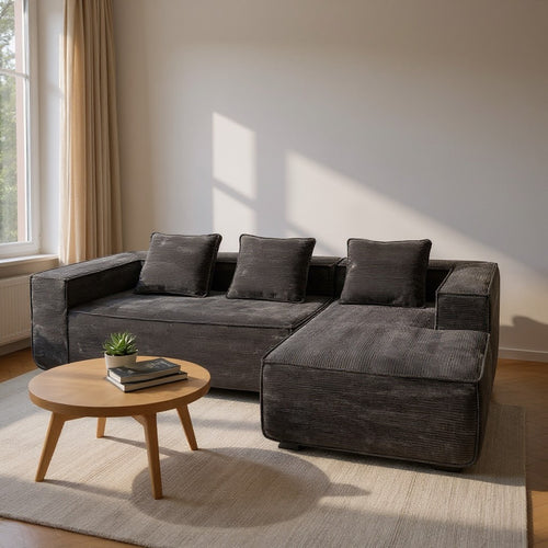 Modern dark gray sectional sofa with chaise, perfect for Sydney living rooms, paired with wooden coffee table.