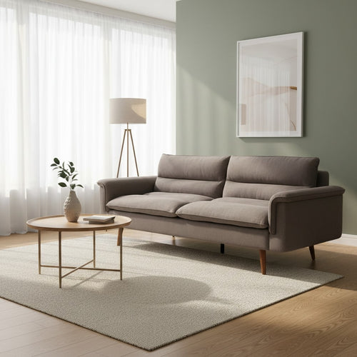 Modern gray fabric sofa with wooden legs in a bright living room with rug and coffee table