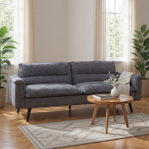 Gray fabric sofa with black legs in modern living room, styled with wooden coffee table and plants