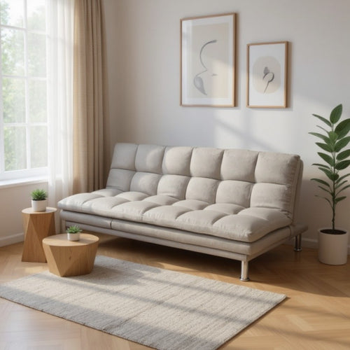 Beige tufted sofa in modern living room with wooden side tables and plants