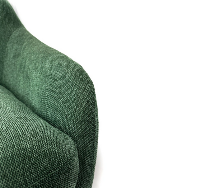 Close-up of textured green fabric upholstered sofa arm and seat cushion