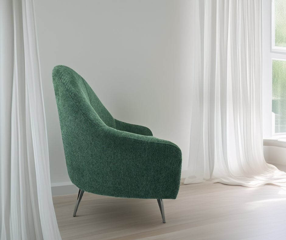 Modern green accent chair with metal legs in a bright living room by sheer white curtains