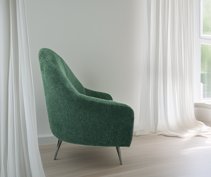 Modern green accent chair with metal legs in a bright living room by sheer white curtains