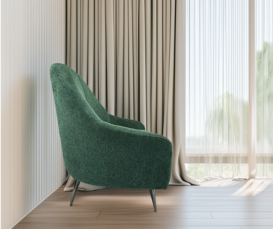 Modern green accent chair with metal legs in a bright living room with floor-to-ceiling curtains