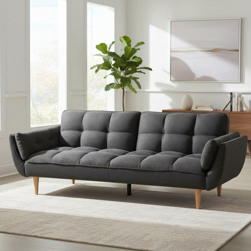 Modern gray tufted sofa with wooden legs in bright living room, ideal for Sydney homes