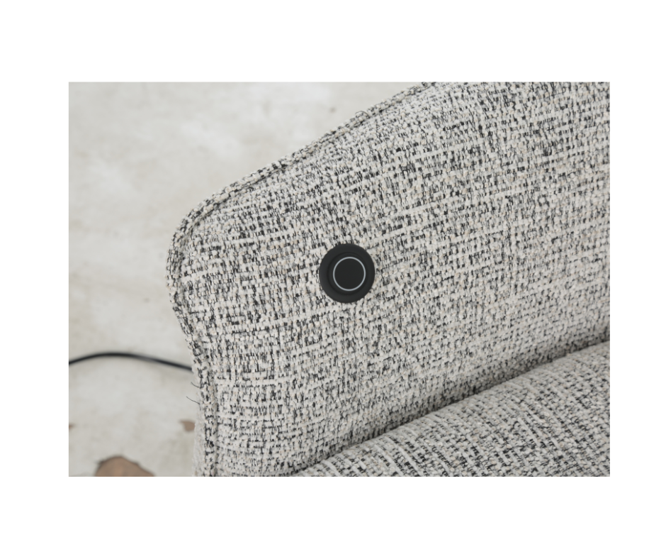 Close-up of light grey upholstered sofa armrest with built-in USB charging port