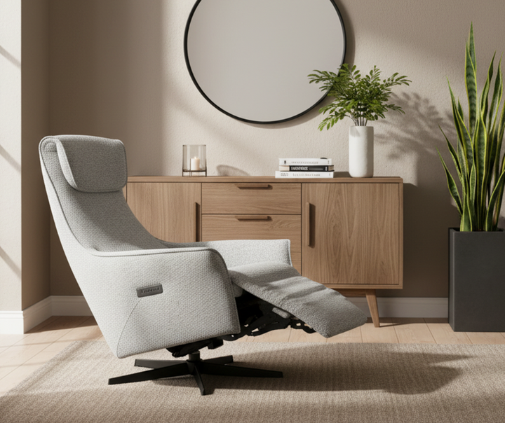 Modern gray reclining lounge chair in cozy living room with wooden sideboard and indoor plants