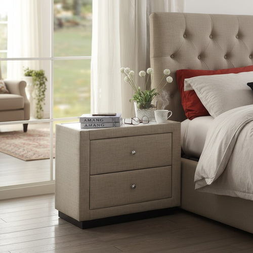Modern beige upholstered nightstand with two drawers beside a tufted bed in a bright bedroom