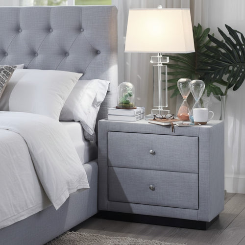 Modern upholstered bed with gray fabric headboard and matching nightstand with lamp in bedroom