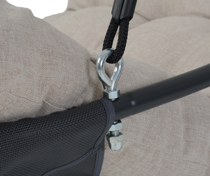 Close-up of a hanging chair hardware with beige cushion and sturdy metal frame