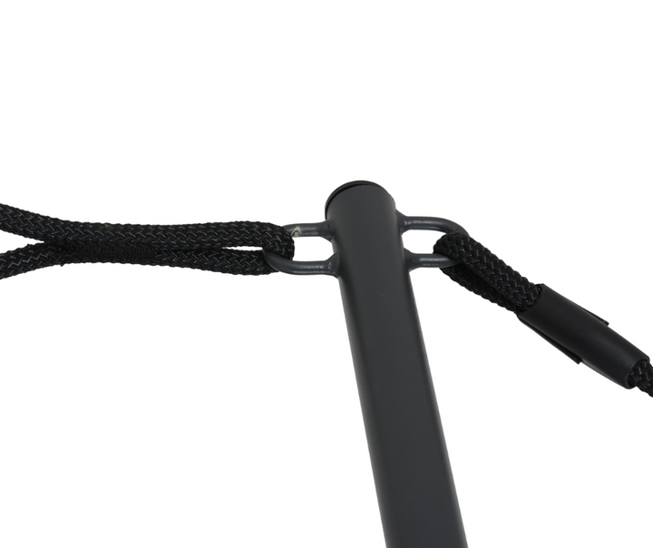 Close-up of a black metal furniture leg with attached braided rope support