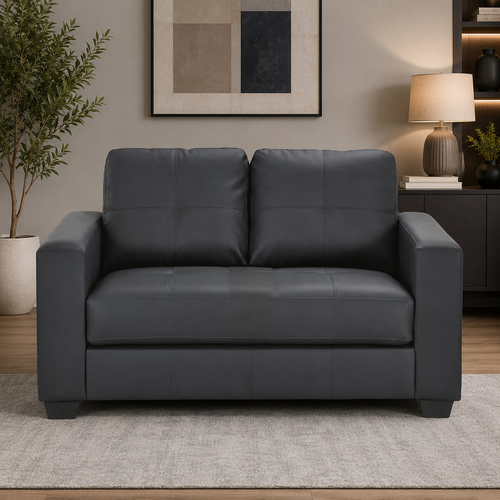 Dark gray leather loveseat sofa in modern living room with rug and decor