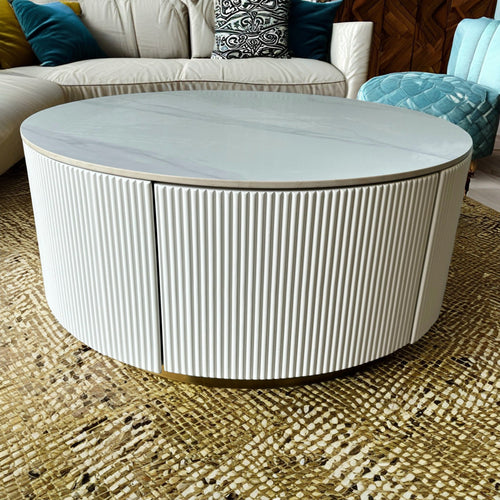 Round white fluted coffee table with marble top in modern living room
