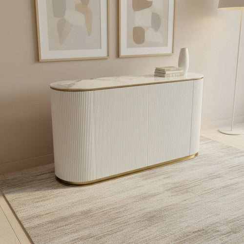 Modern white console table with marble top and gold trim in a minimalist living room
