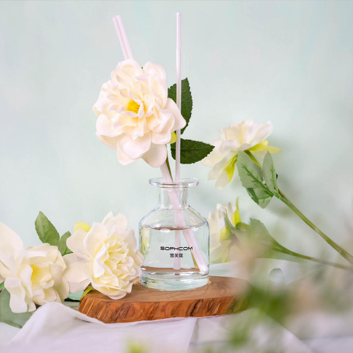 Glass vase with white artificial flower decor on wooden tray, soft pastel background