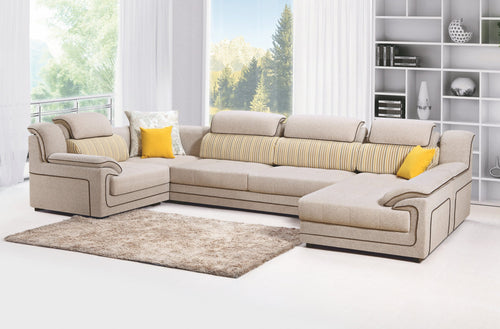 Beige sectional sofa with striped cushions and yellow pillows in modern living room