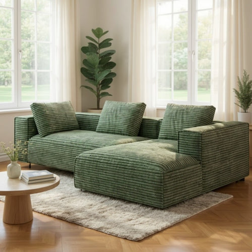 Green corduroy sectional sofa with chaise in bright living room, modern furniture design