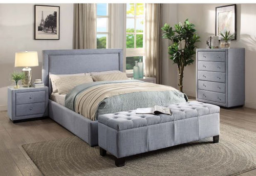 Modern grey upholstered bed set with bench, nightstand, and dresser in bright bedroom