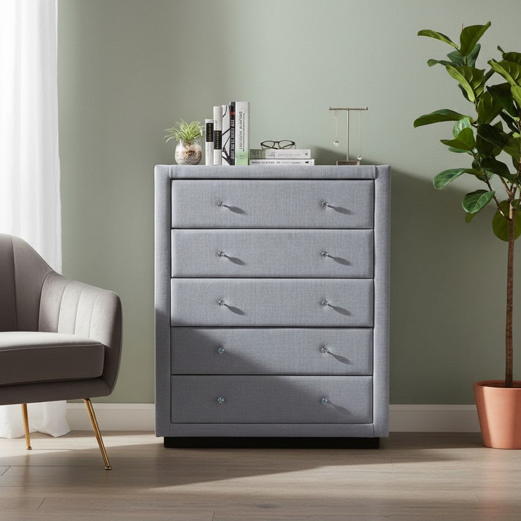 Modern gray upholstered dresser with crystal handles in a stylish living room setting