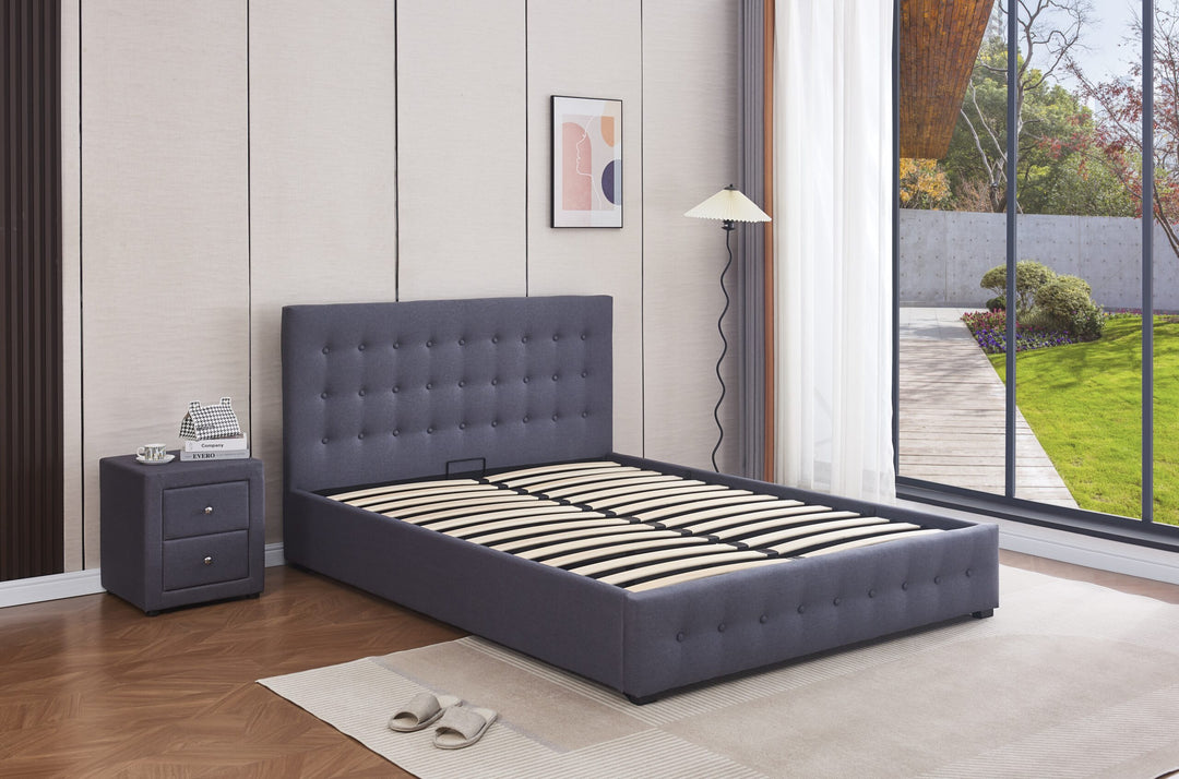Modern gas lift storage bed with tufted grey headboard in a bright bedroom