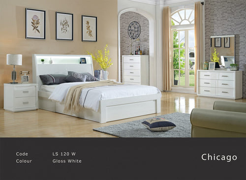 Modern gloss white bedroom suite with bed, dresser, drawers, nightstand and large window.