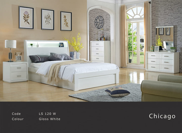 Modern gloss white bedroom suite with bed, dresser, drawers, nightstand and large window.