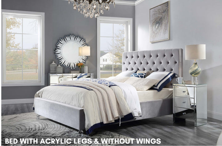 Modern tufted bed with acrylic legs, no wings, in a stylish gray bedroom setting.