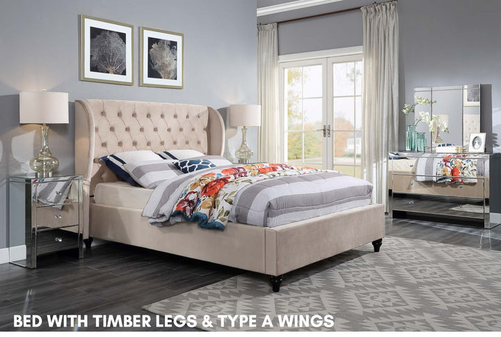 Upholstered bed with timber legs and wingback headboard in modern bedroom setting