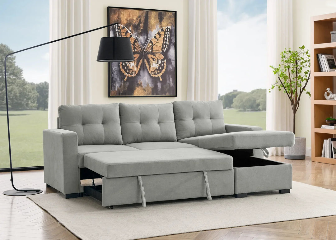 Light grey sectional sofa bed with storage chaise in modern living room with large windows