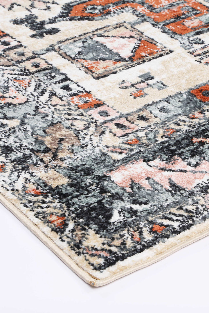 Beige and orange area rug with geometric pattern and textured surface on white background