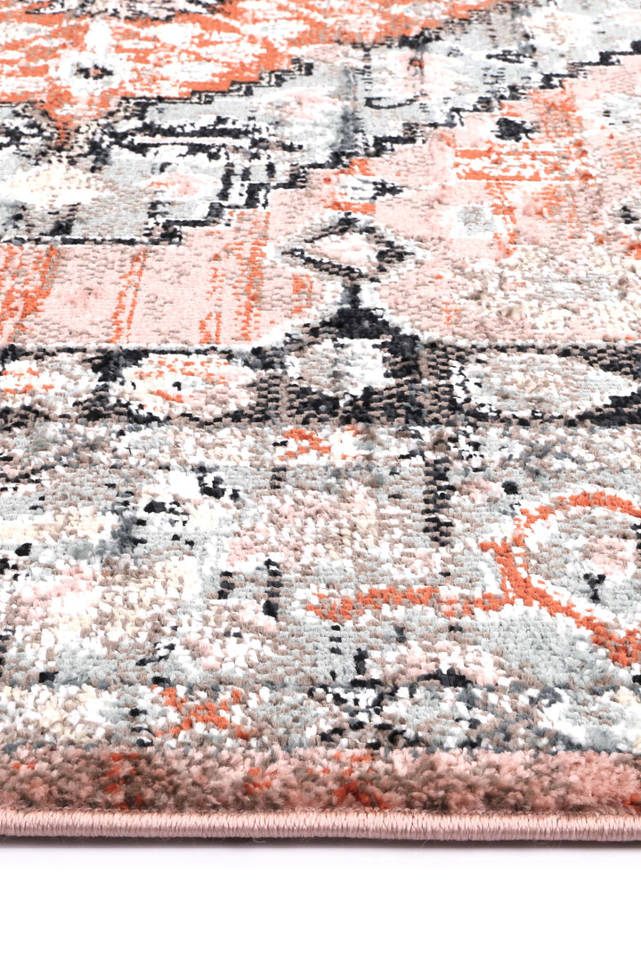Beige and orange patterned area rug with textured pile close-up