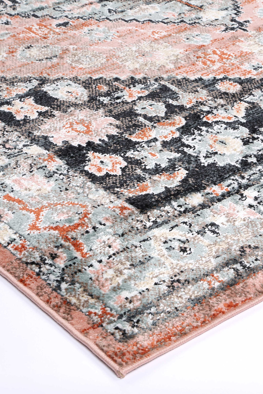 Beige area rug with abstract floral pattern in peach, grey, and black tones on white background