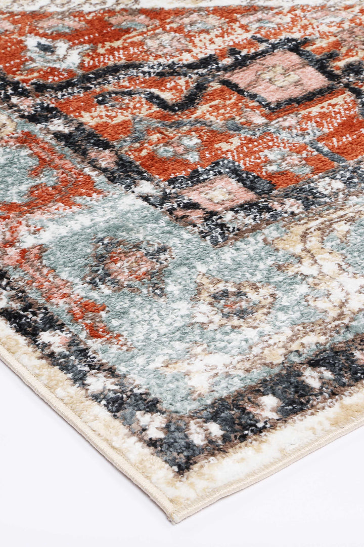 Close-up of a multicolor area rug with red, blue, and beige geometric patterns