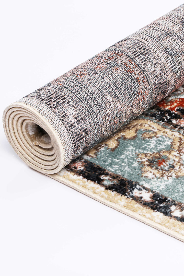 Rolled area rug with intricate multicolor traditional pattern on soft pile