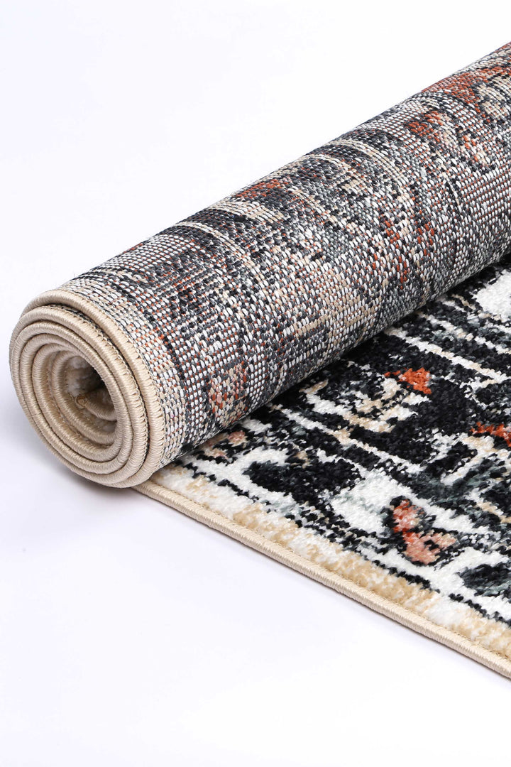 Rolled area rug with multicolor abstract pattern and textured weave on white background