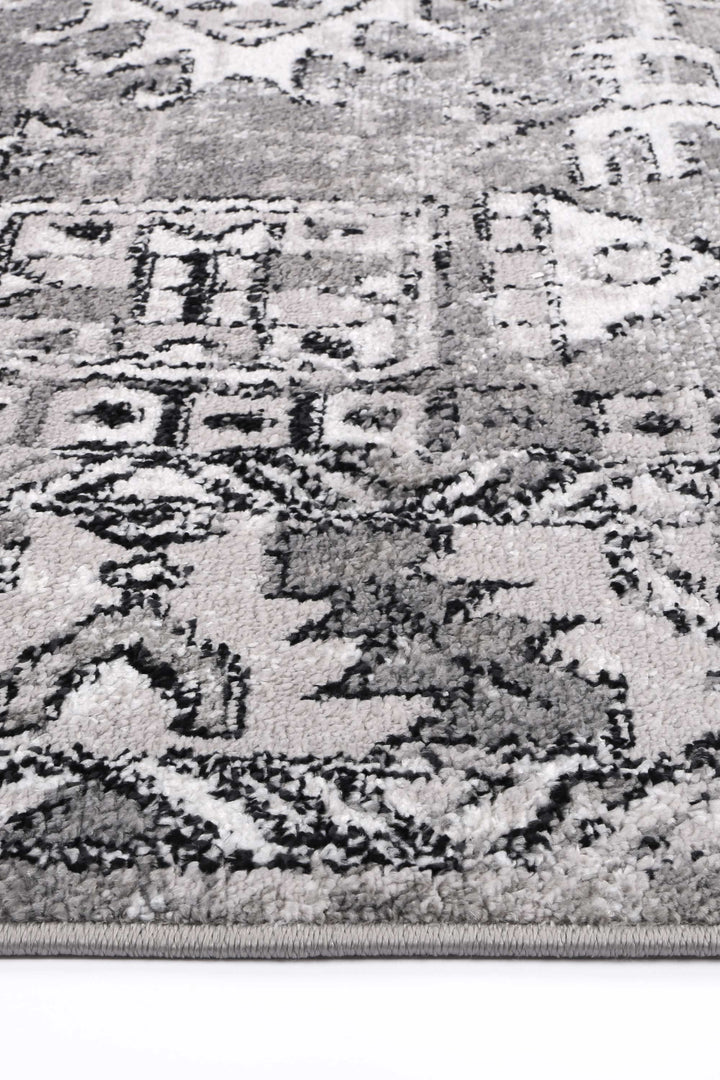 Close-up of grey area rug with plush texture and geometric pattern, home decor