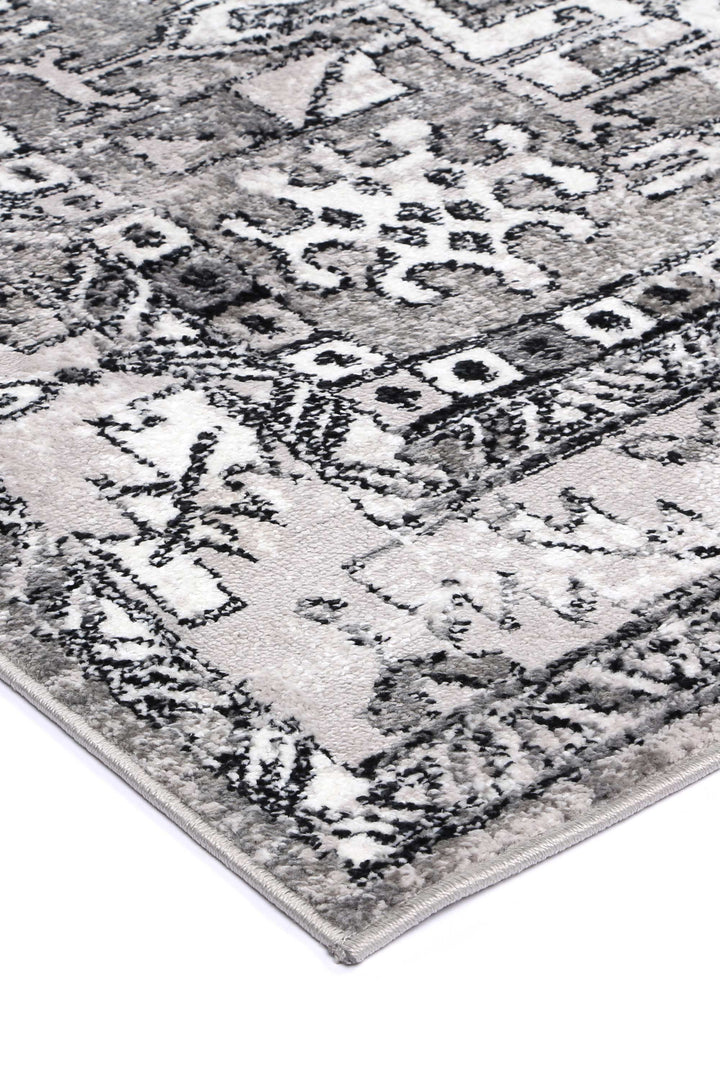 Grey and white area rug with textured, geometric and floral patterns, modern home decor.