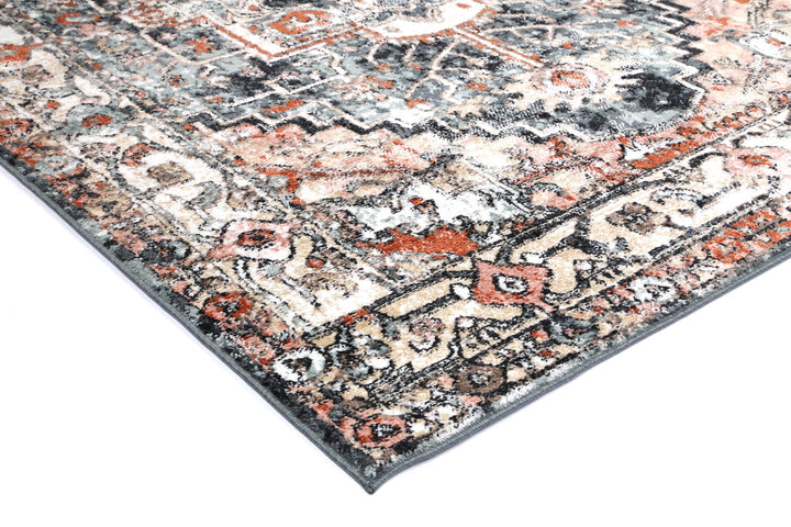 Corner of multicolor oriental area rug with vintage pattern on white background