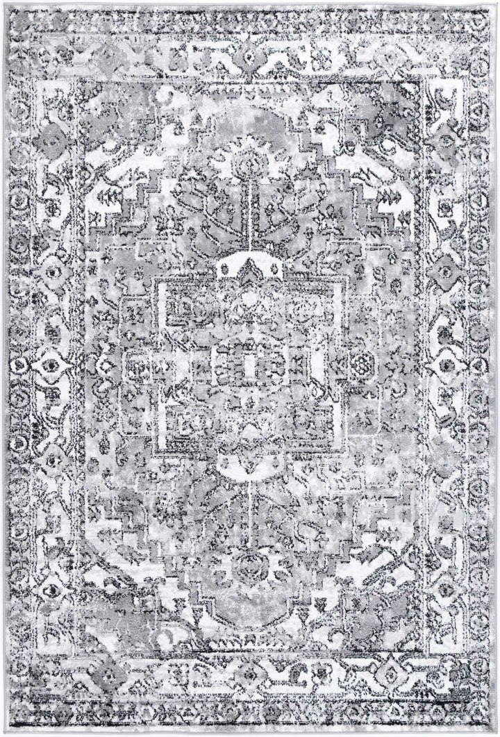 Grey area rug with vintage-inspired geometric and floral pattern, distressed design.