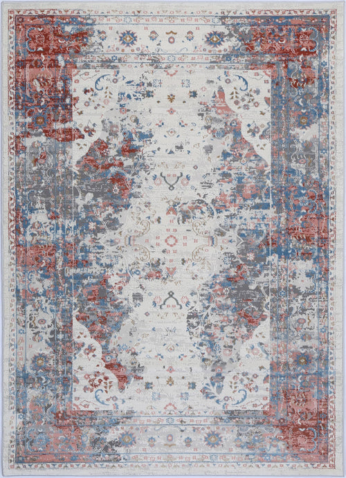 Vintage distressed area rug with red, blue, and gray floral patterns on a light background